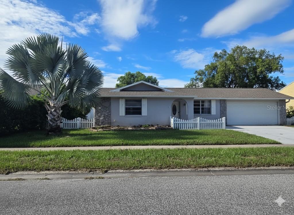12427 Willow Tree Avenue Hudson, FL 34669 - Photo 27 of 27 a front view of a house with a garden