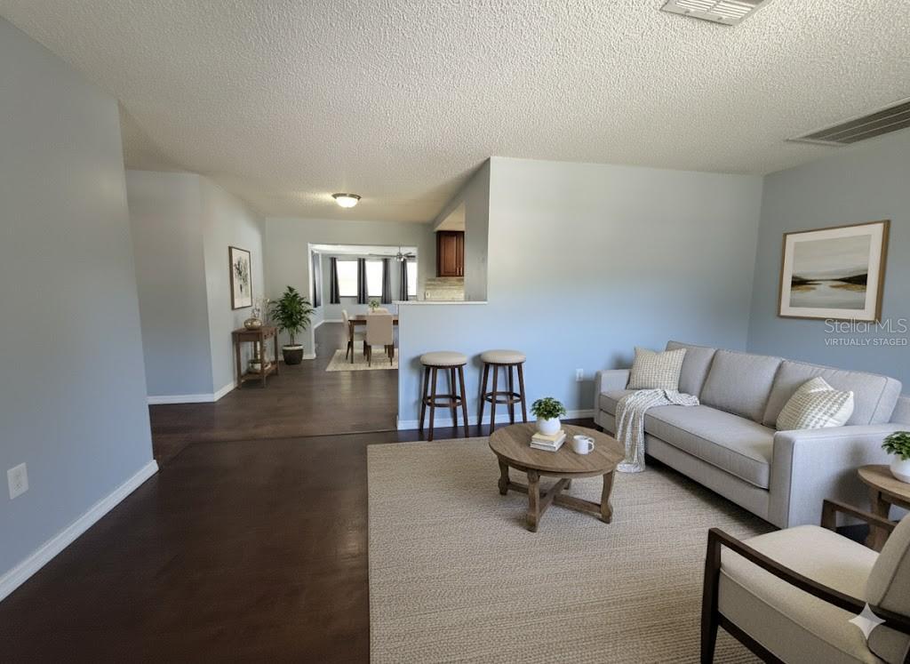 12427 Willow Tree Avenue Hudson, FL 34669 - Photo 4 of 27 a living room with furniture and a dining table with wooden floor