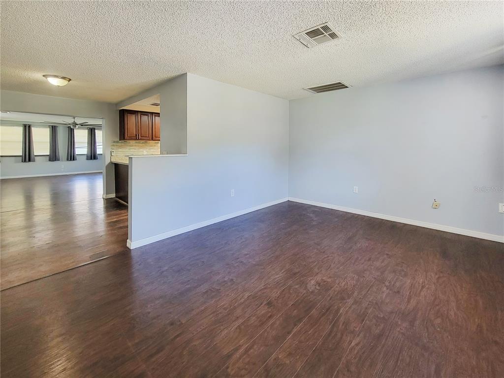 12427 Willow Tree Avenue Hudson, FL 34669 - Photo 6 of 27 a view of a livingroom with wooden floor and a flat screen tv