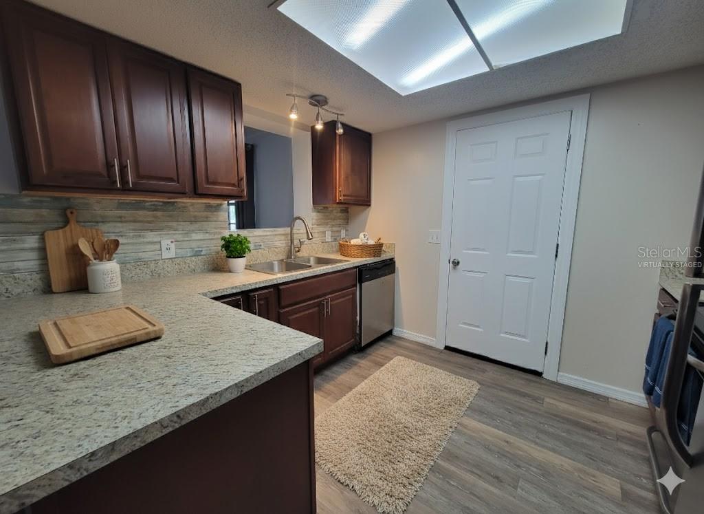 12427 Willow Tree Avenue Hudson, FL 34669 - Photo 9 of 27 a kitchen with a sink a stove and cabinets