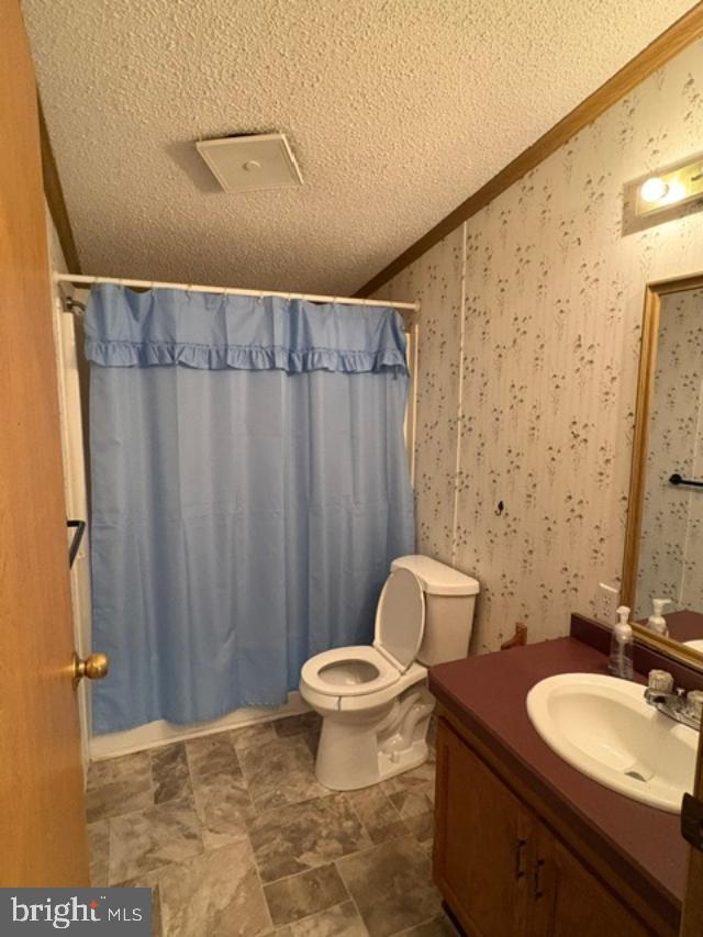 48 Jeffrey Road Gordonville, PA 17529 - Photo 7 of 12 a bathroom with a granite countertop sink a toilet and a mirror