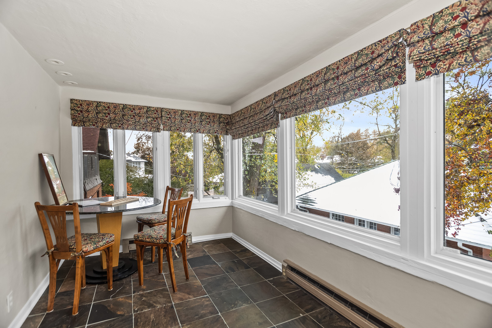 2528 Sheridan Road Evanston, IL 60201 - Photo 40 of 55 a view of a dining room with furniture large windows and wooden floor