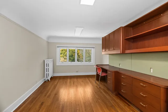 a kitchen with stainless steel appliances granite countertop a refrigerator and a wooden floor