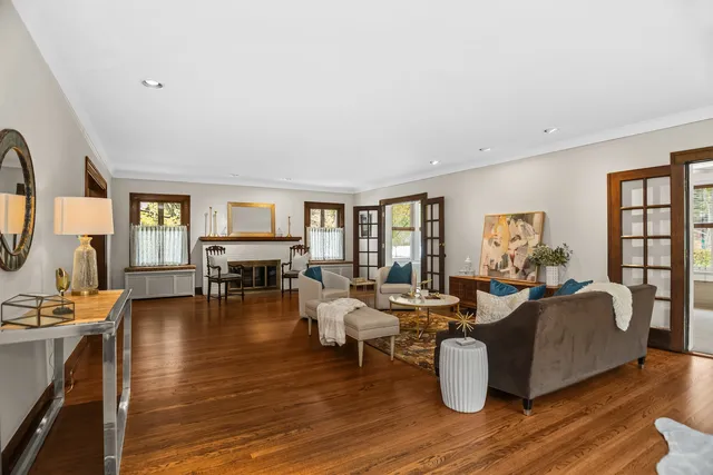 a living room with fireplace furniture and a wooden floor