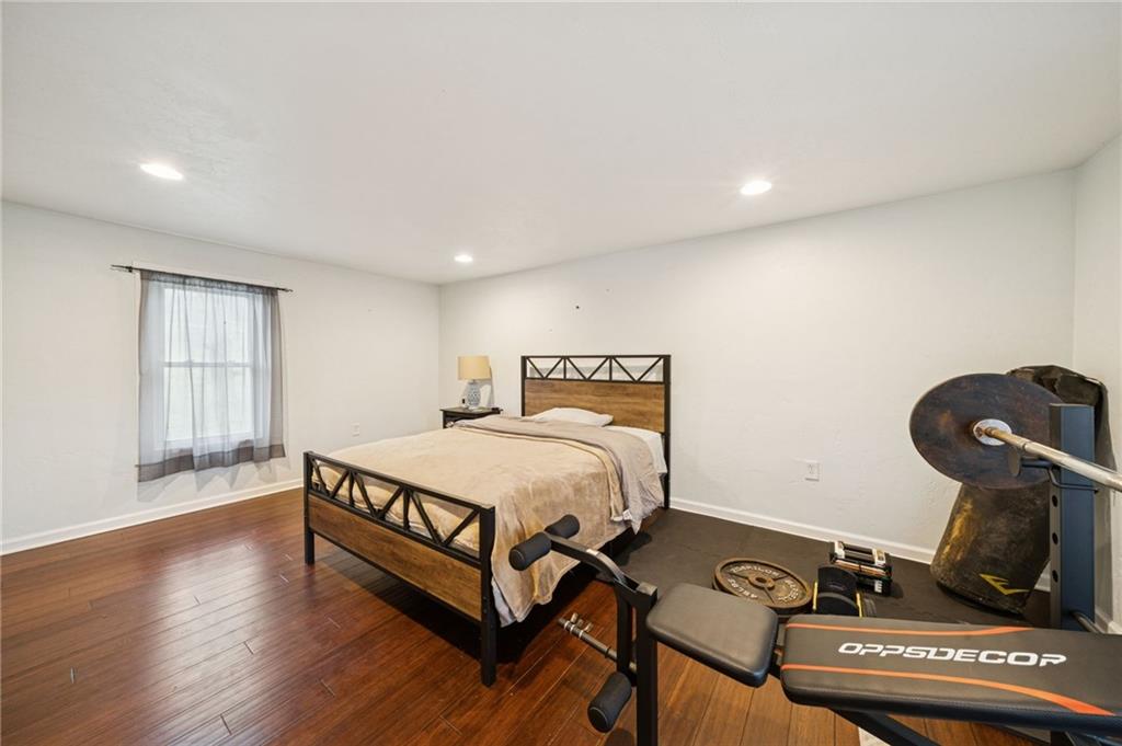869 Middletown Road New Stanton, PA 15672 - Photo 14 of 30 a spacious bedroom with a bed and wooden floor