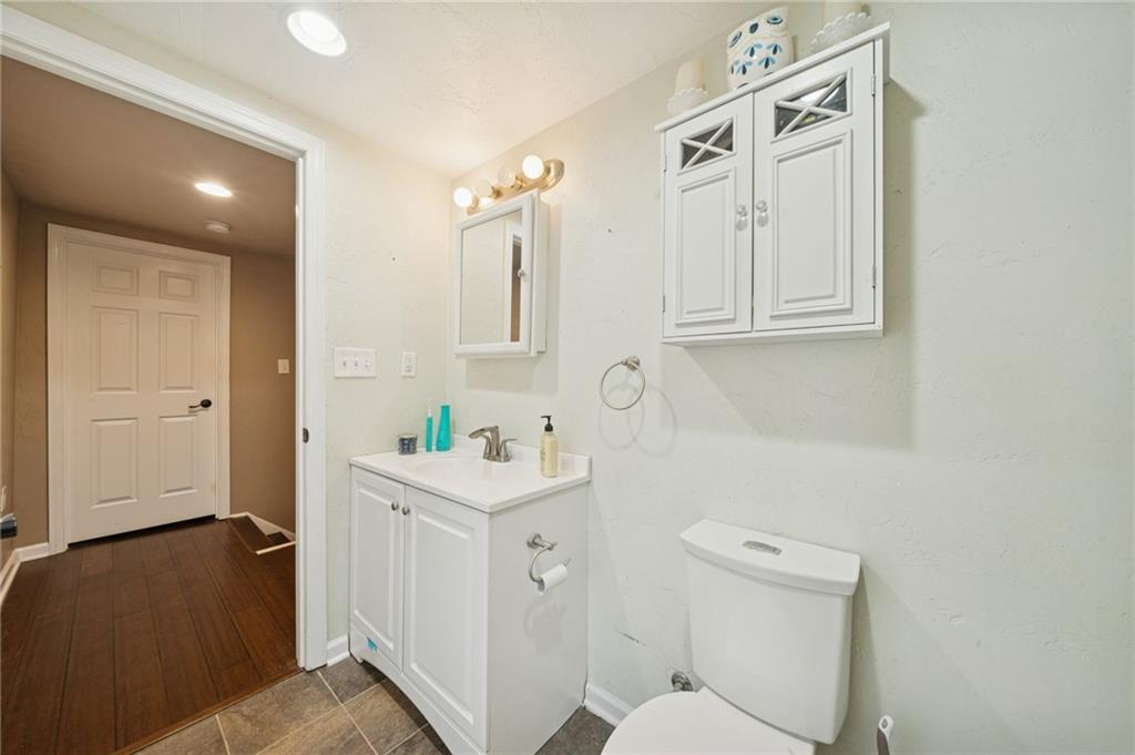 869 Middletown Road New Stanton, PA 15672 - Photo 17 of 30 a bathroom with a toilet a sink a vanity and mirror