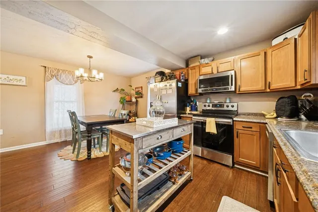 a kitchen with a sink appliances and cabinets