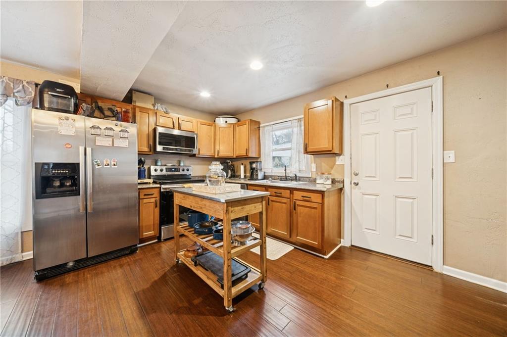 869 Middletown Road New Stanton, PA 15672 - Photo 9 of 30 a kitchen with kitchen island wooden floors appliances and cabinets