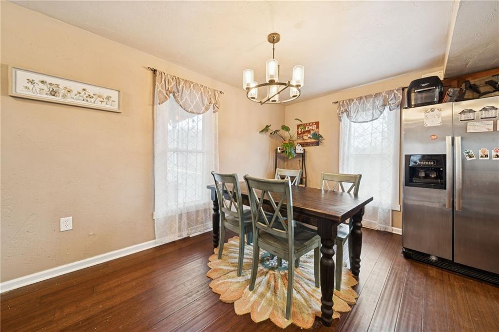 869 Middletown Road New Stanton, PA 15672 - Photo 10 of 30 a view of a dining room with furniture a chandelier and wooden floor