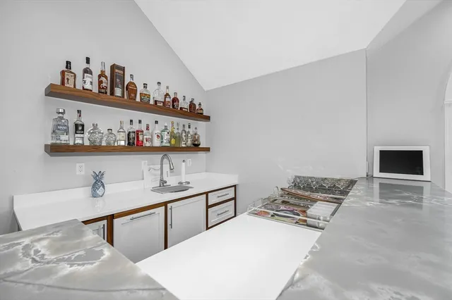 a spacious bedroom with a bed and a flat screen tv