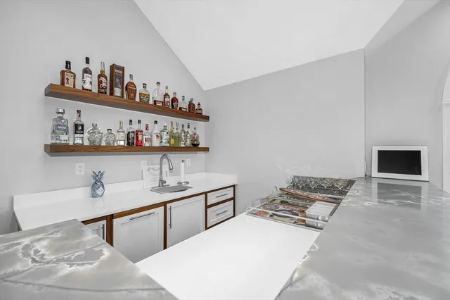 a bedroom with a bed and a shelf with books