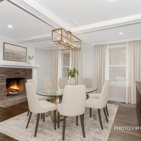 a view of a dining room with furniture and a chandelier