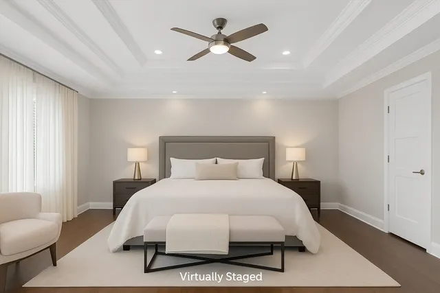 a large kitchen with stainless steel appliances kitchen island granite countertop a stove top oven a refrigerator and white cabinets with wooden floor