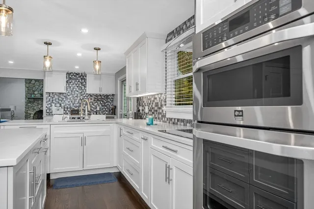 a kitchen with stainless steel appliances a stove microwave and cabinets