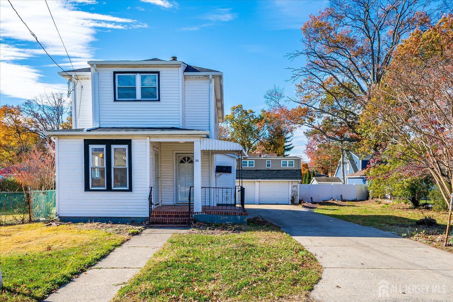 385 Pierson Avenue, Unit 2 Edison, NJ 08837 - Photo 1 of 18 a front view of a house with a yard garage and trees