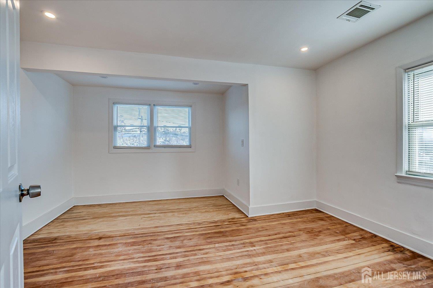 385 Pierson Avenue, Unit 2 Edison, NJ 08837 - Photo 12 of 18 a view of empty room with wooden floor and fan