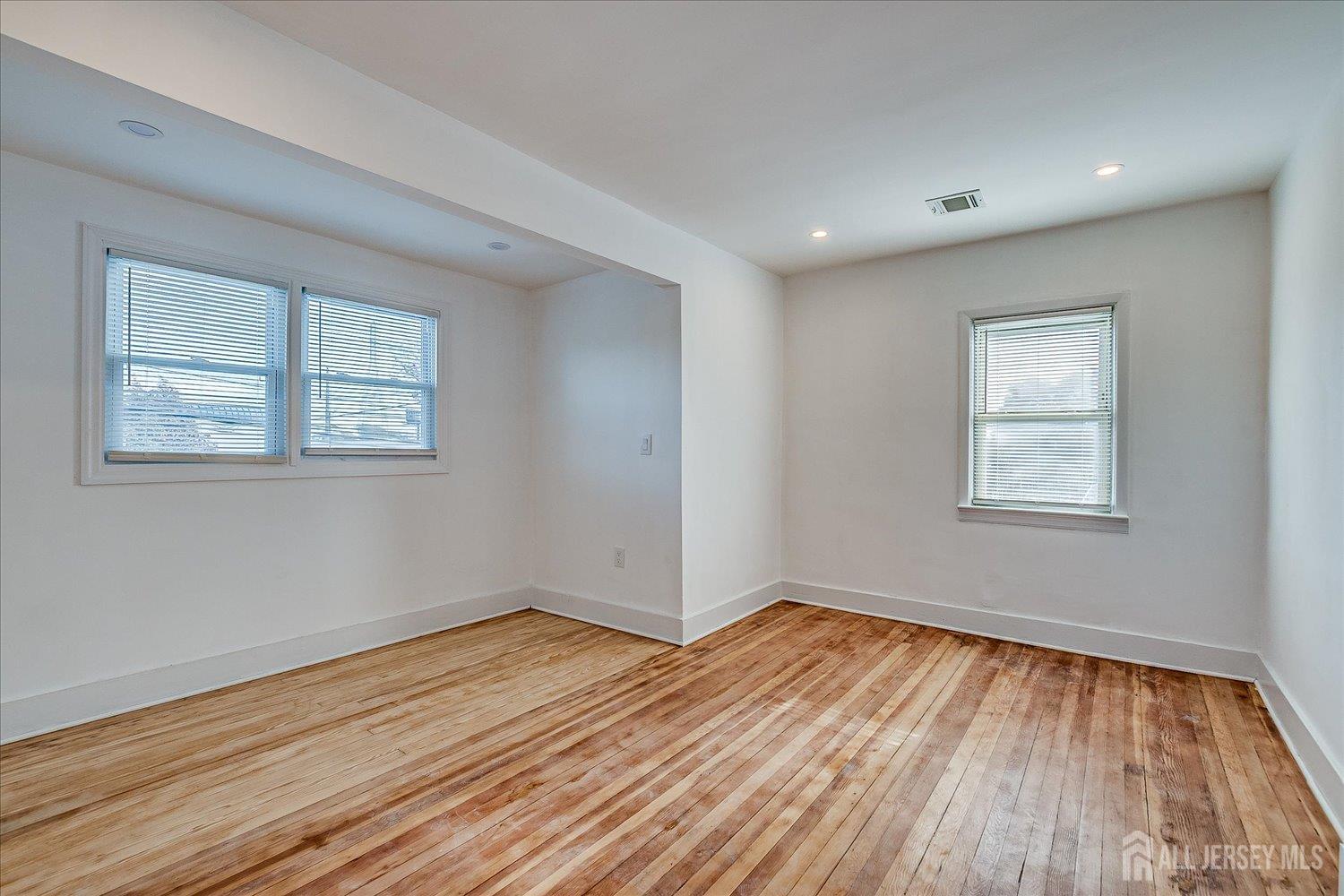 385 Pierson Avenue, Unit 2 Edison, NJ 08837 - Photo 14 of 18 a view of empty room with wooden floor and fan