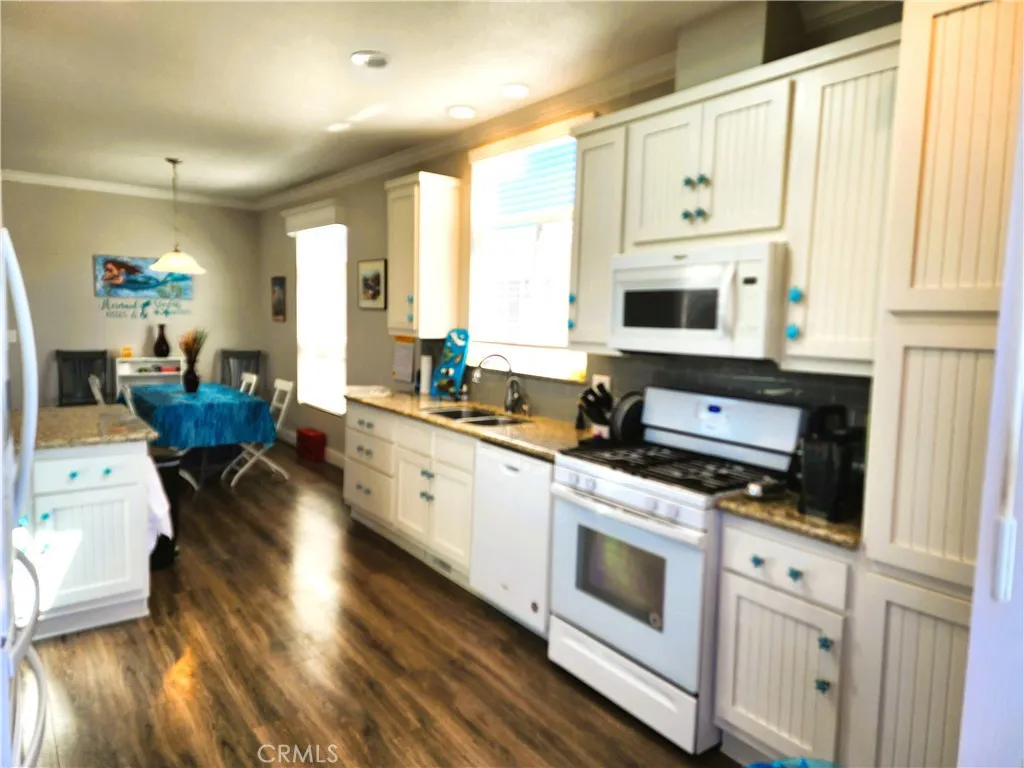 500 Atascadero, Unit E02 Morro Bay, CA 93442 - Photo 19 of 40 a kitchen with stainless steel appliances a stove a sink and white cabinets
