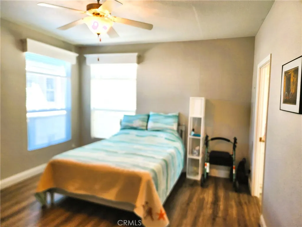 500 Atascadero, Unit E02 Morro Bay, CA 93442 - Photo 29 of 40 a bedroom with a bed and a chandelier