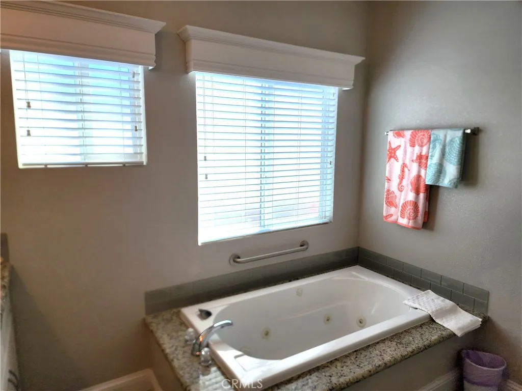 500 Atascadero, Unit E02 Morro Bay, CA 93442 - Photo 33 of 40 a bath tub sitting in a bathroom next to a window
