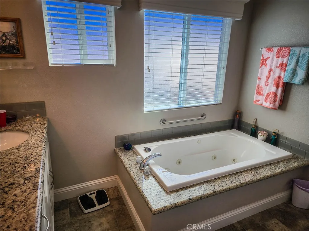 500 Atascadero, Unit E02 Morro Bay, CA 93442 - Photo 5 of 40 a bathroom with a tub and a window