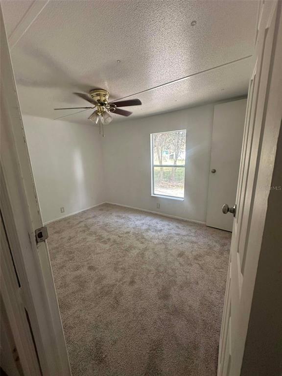 6445 Southeast 173 Lane Summerfield, FL 34491 - Photo 14 of 42 a view of a livingroom with a ceiling fan and window