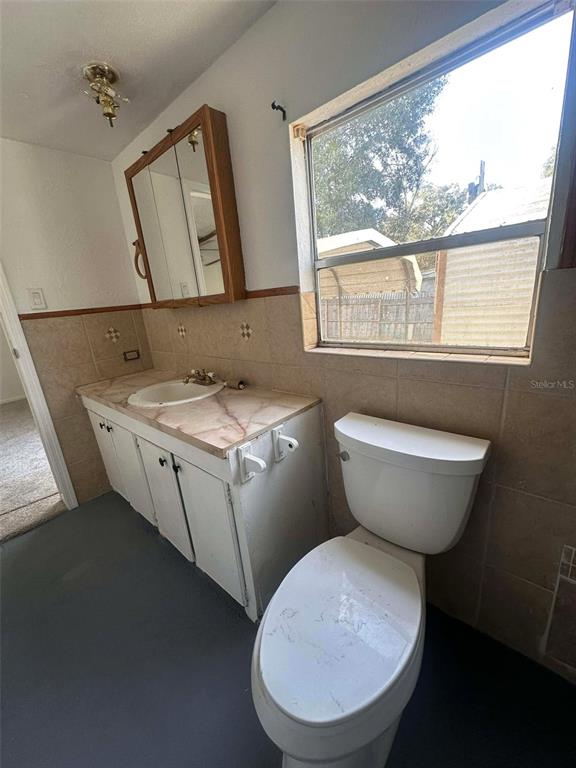 6445 Southeast 173 Lane Summerfield, FL 34491 - Photo 19 of 42 a bathroom with a toilet sink and mirror