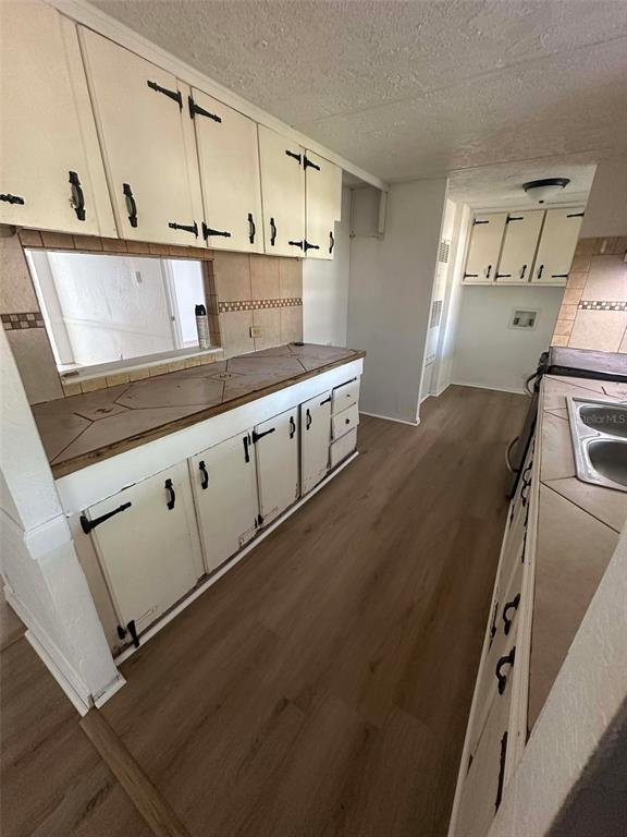 6445 Southeast 173 Lane Summerfield, FL 34491 - Photo 33 of 42 a kitchen with granite countertop a sink a stove and cabinets