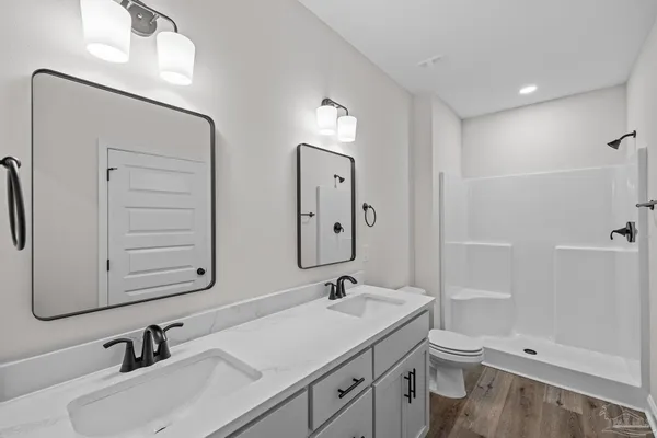 a bathroom with 2 sink and a mirror