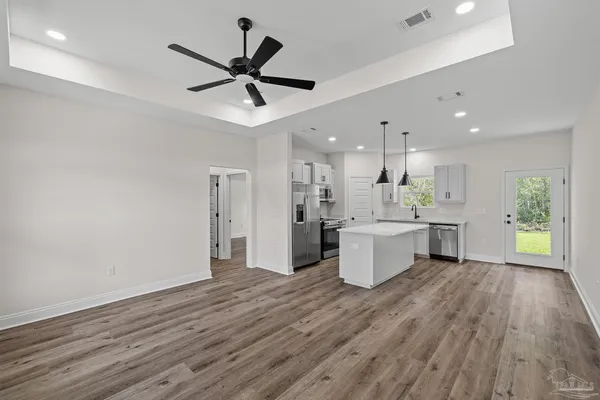 a view of kitchen with wooden floor and window
