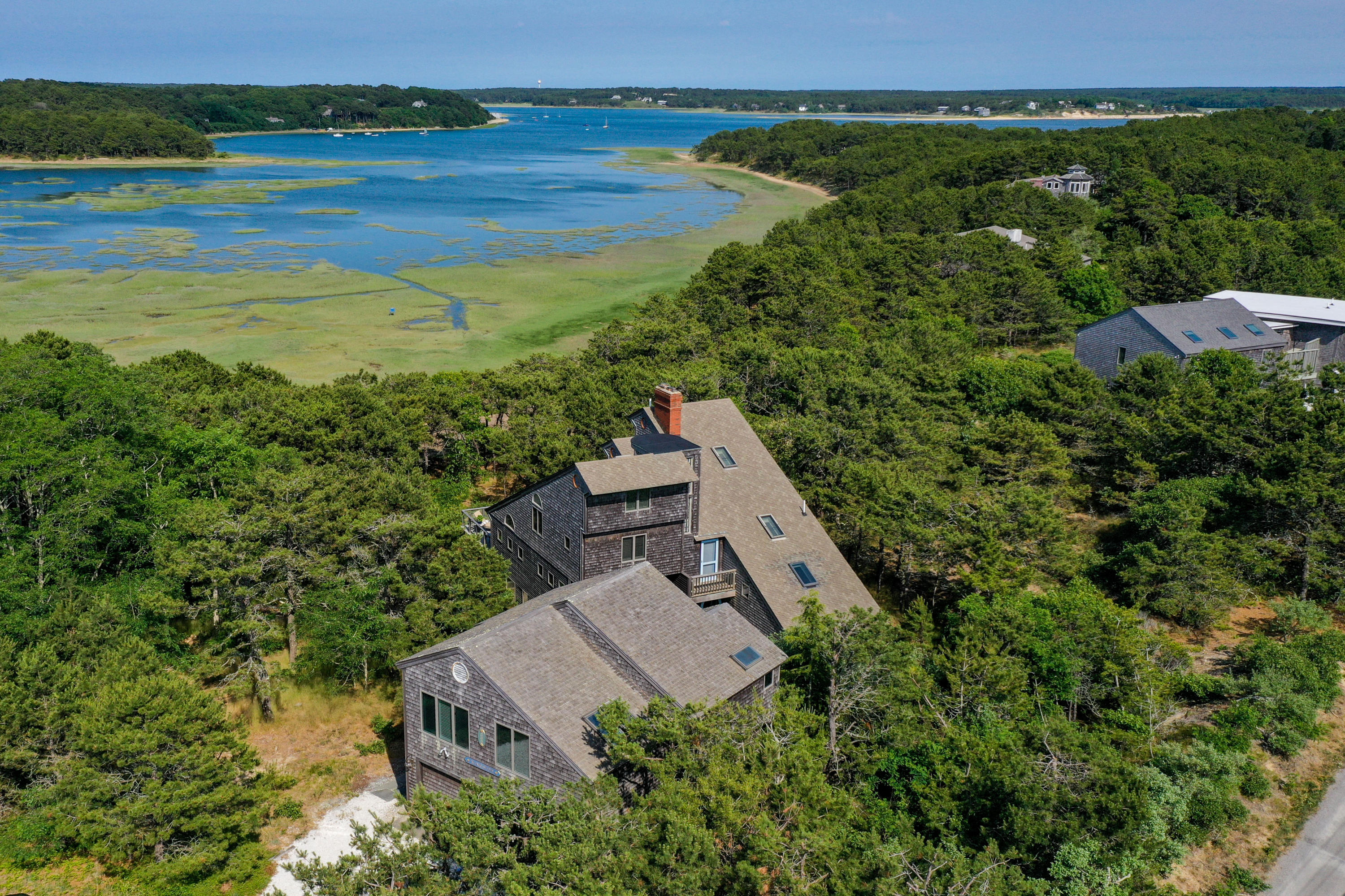 an aerial view of a house with a garden and lake view