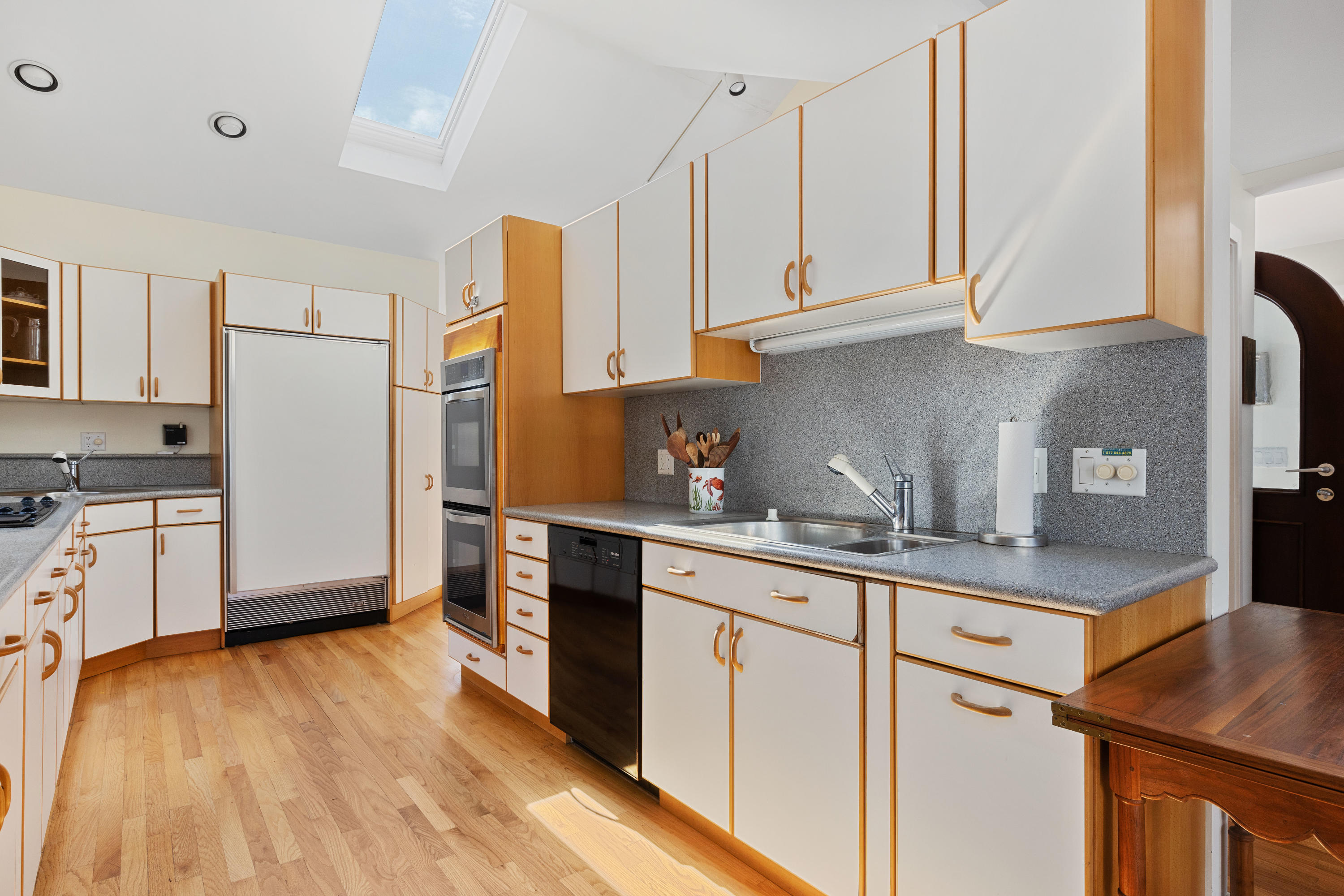 265 King Phillip Road Wellfleet, MA 02667 - Photo 13 of 85 a kitchen with stainless steel appliances granite countertop a sink a stove a refrigerator and white cabinets with wooden floor