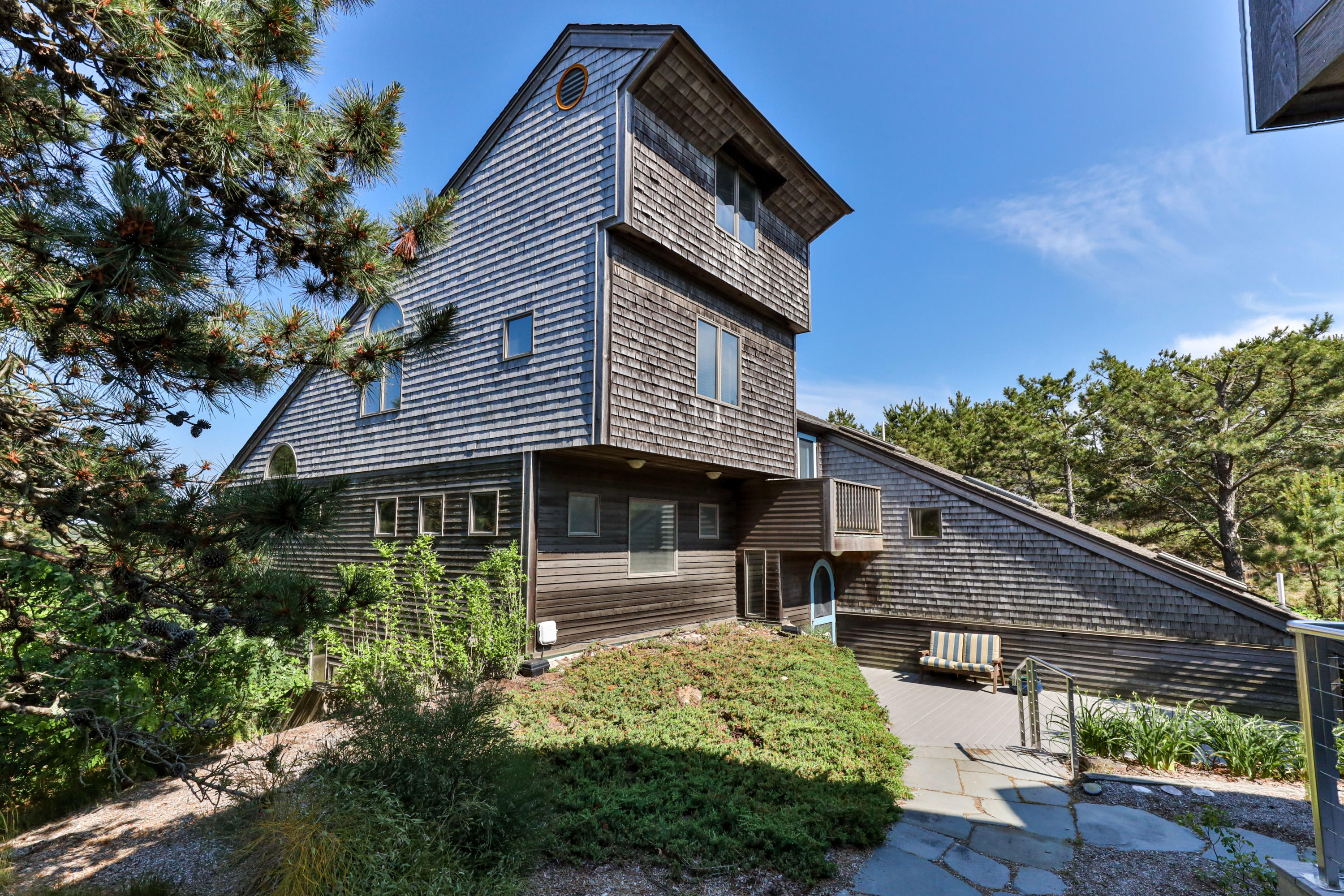 265 King Phillip Road Wellfleet, MA 02667 - Photo 3 of 85 a front view of a house with garden