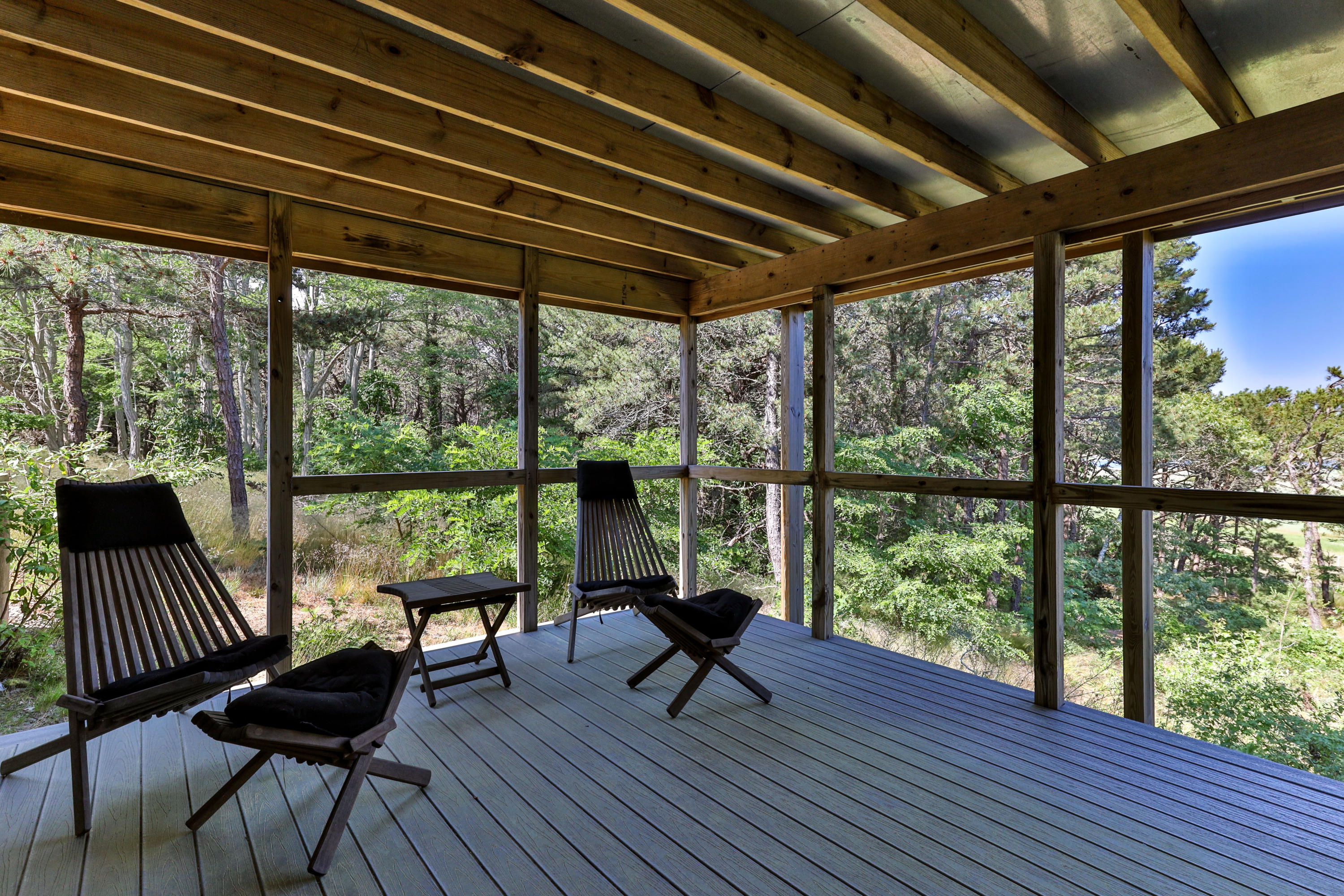 265 King Phillip Road Wellfleet, MA 02667 - Photo 32 of 85 a living room with furniture and a floor to ceiling window