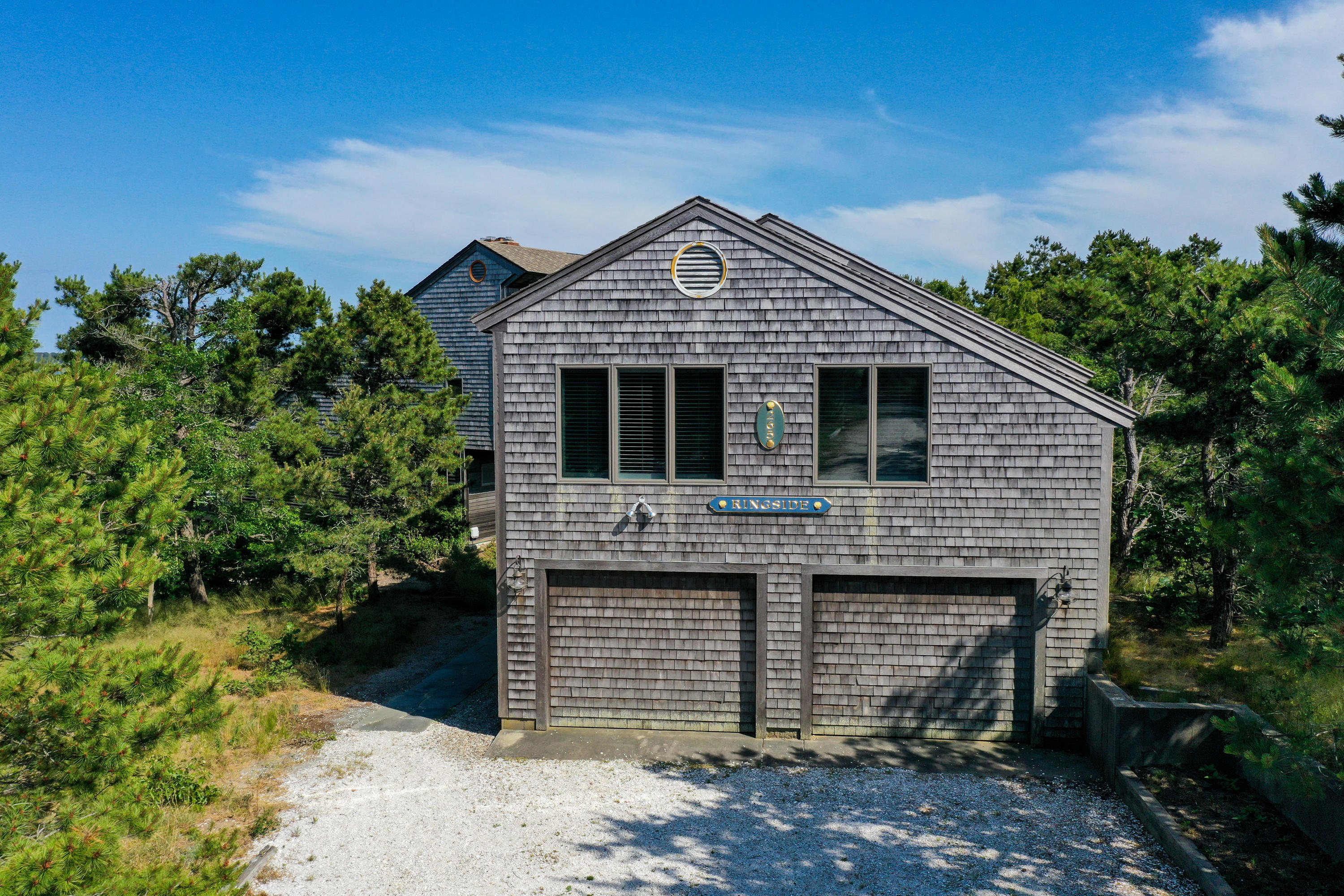 265 King Phillip Road Wellfleet, MA 02667 - Photo 4 of 85 a front view of a house with a garden
