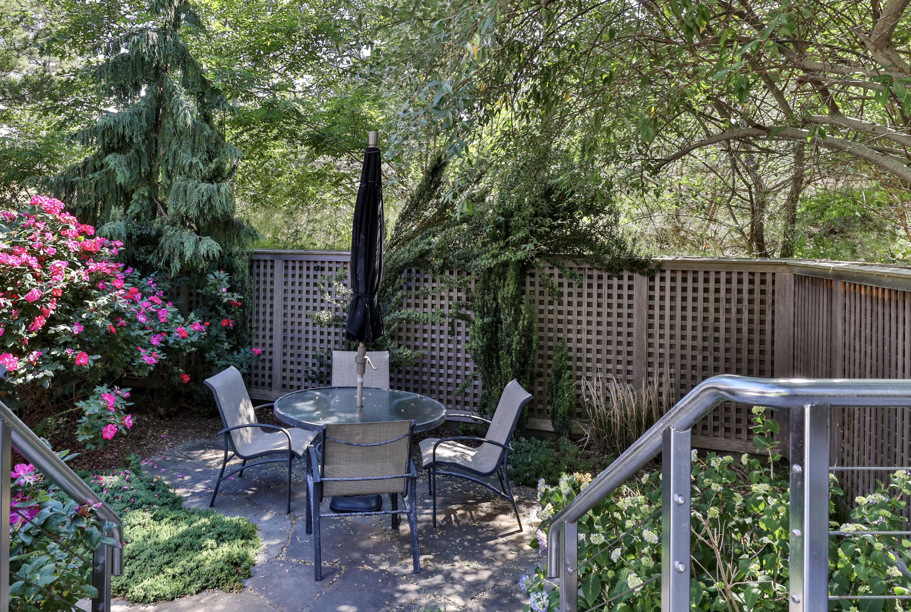 265 King Phillip Road Wellfleet, MA 02667 - Photo 52 of 85 a view of a deck with furniture and flowers
