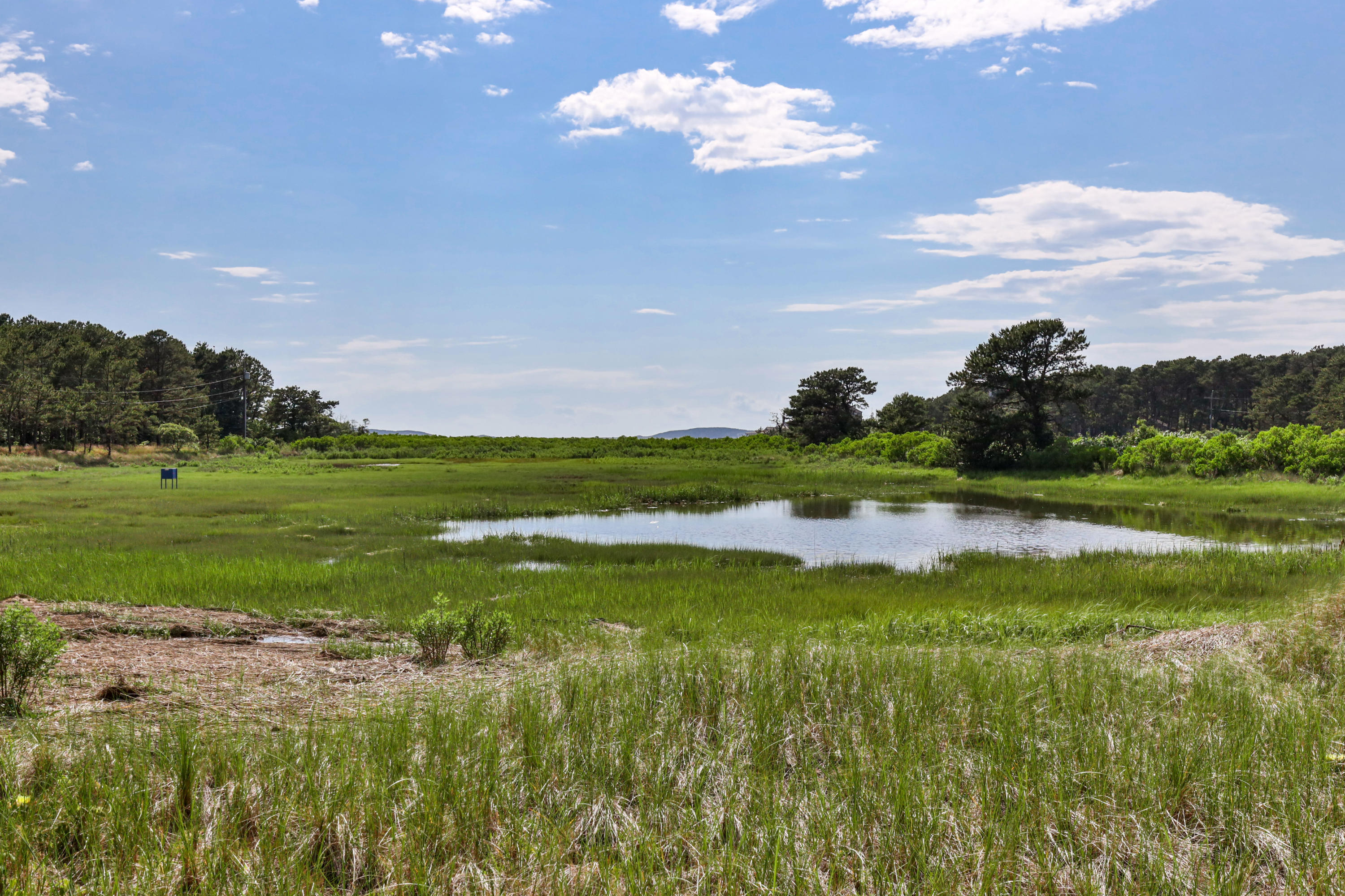 265 King Phillip Road Wellfleet, MA 02667 - Photo 65 of 85 a view of a golf course with a lake