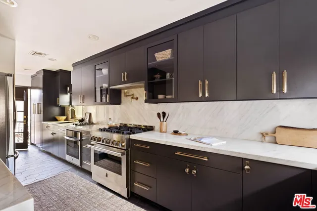 a kitchen with a sink stove and cabinets