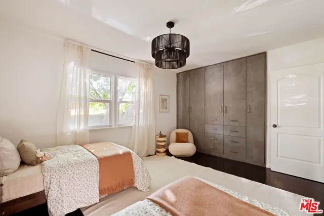 a bedroom with a bed and a chandelier