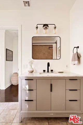 a bathroom with a sink and a mirror