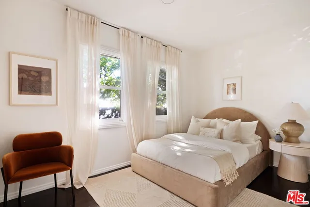 a bedroom with a bed and chair