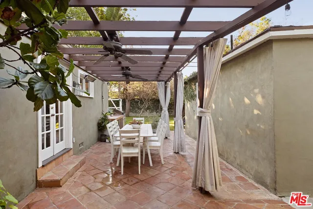 a view of a porch with chairs and potted plants