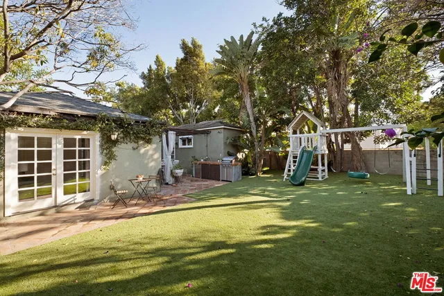 a swimming pool with outdoor seating and yard