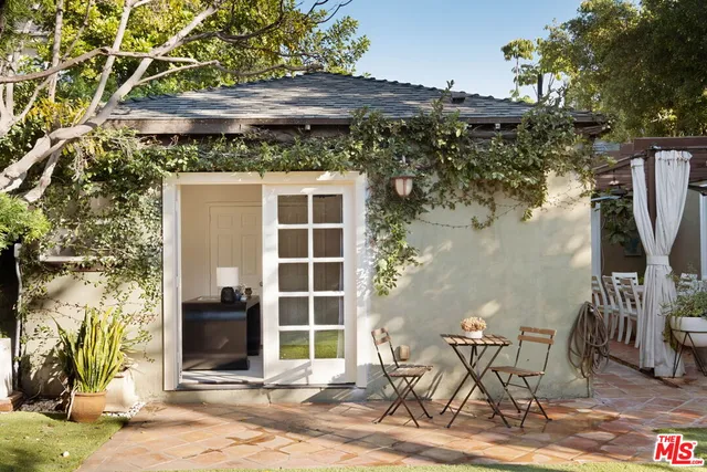 a backyard of a house with table and chairs