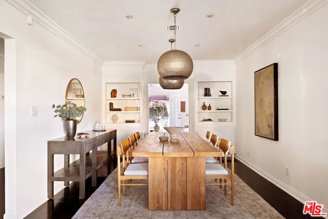a dining room with furniture and wooden floor
