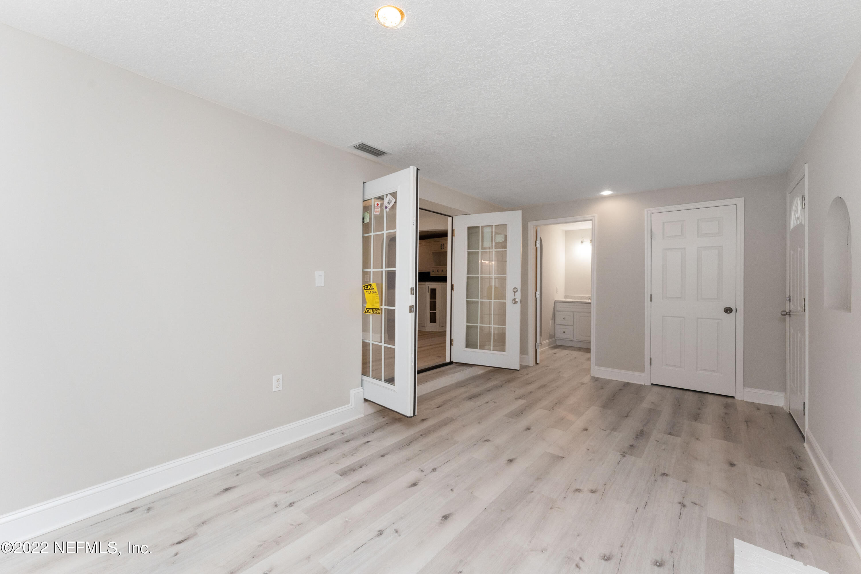 6216 Temple Road Jacksonville, FL 32217 - Photo 13 of 25 a view of an empty room with wooden floor and closet