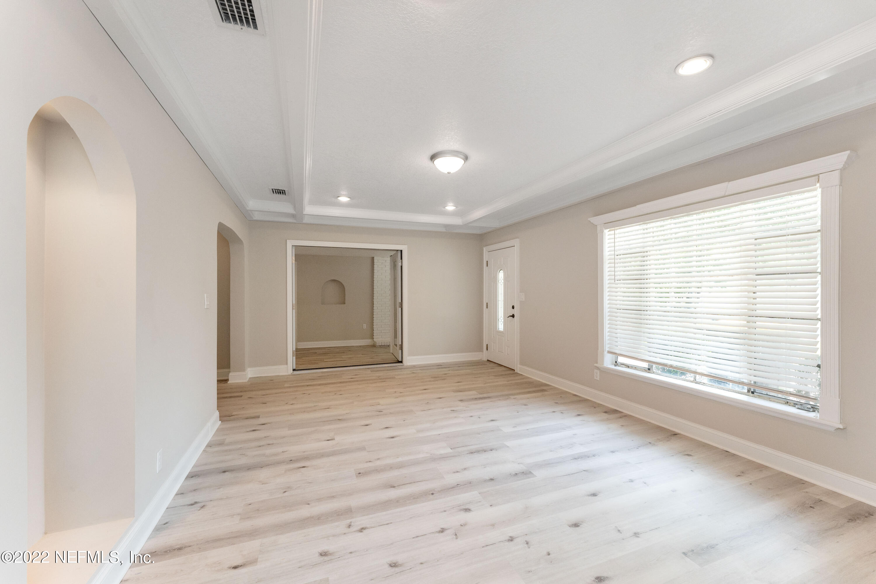 6216 Temple Road Jacksonville, FL 32217 - Photo 4 of 25 a view of an empty room with wooden floor and a window