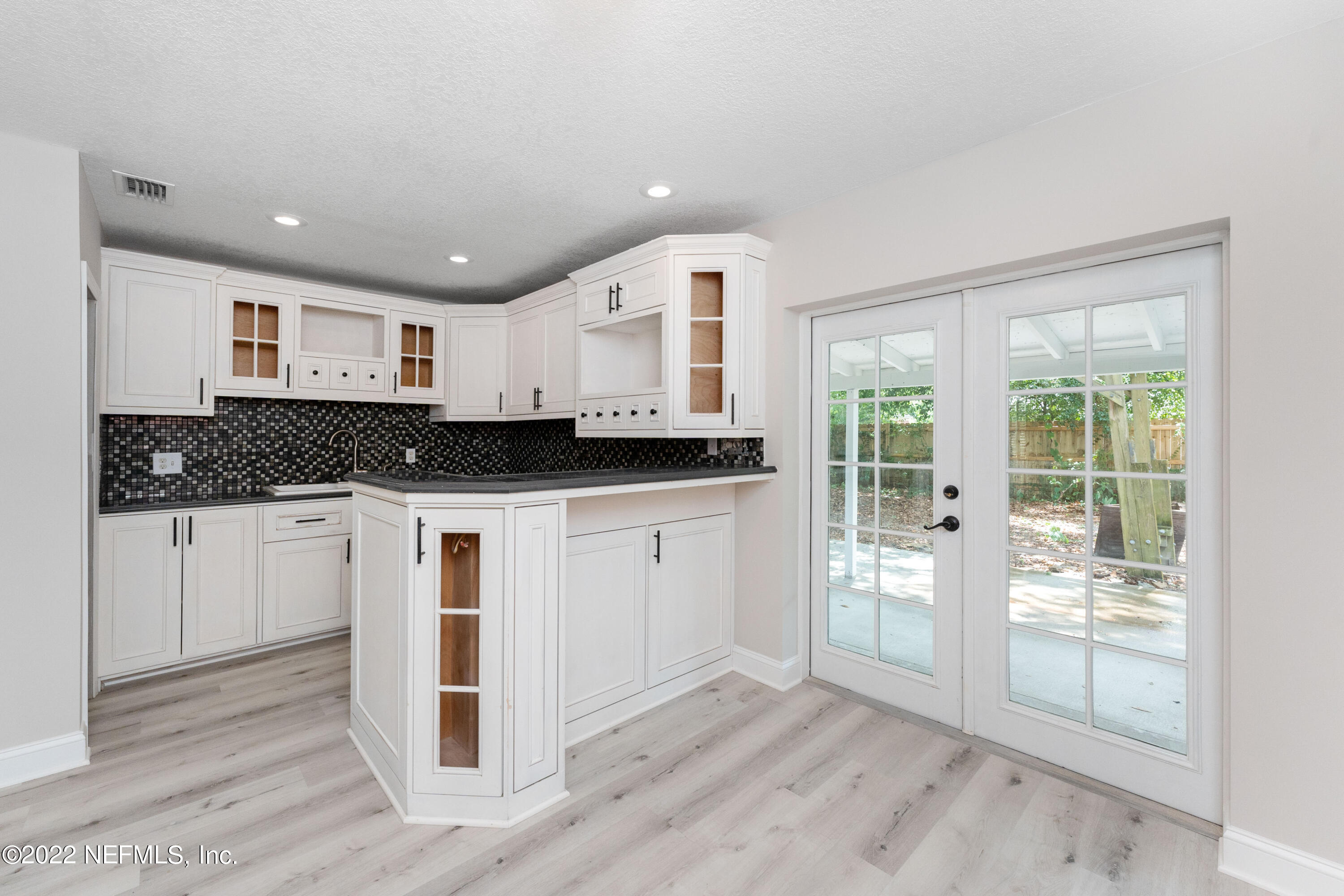6216 Temple Road Jacksonville, FL 32217 - Photo 6 of 25 a view of kitchen with stainless steel appliances granite countertop a stove a refrigerator a sink and white cabinets with wooden floor