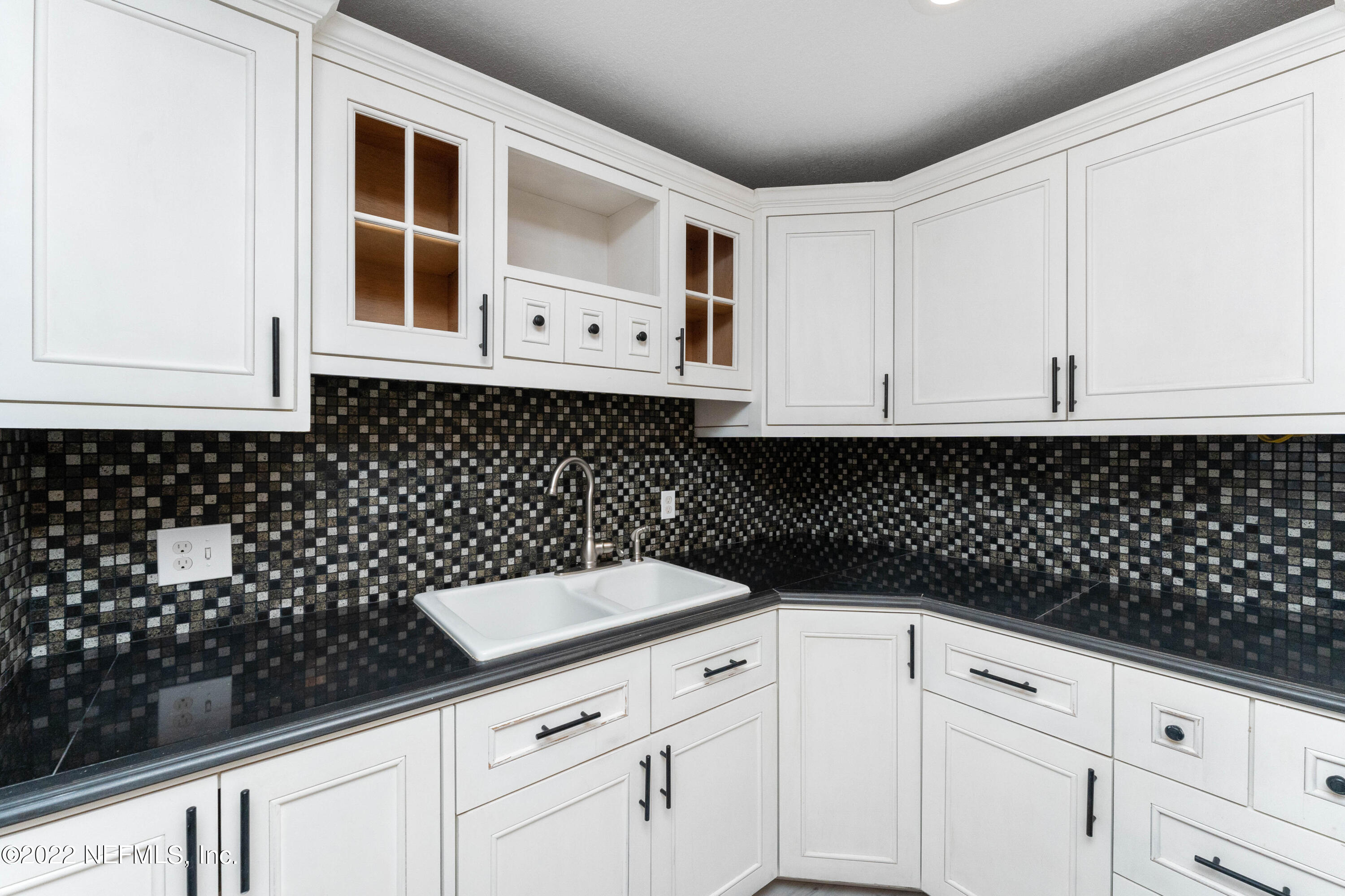6216 Temple Road Jacksonville, FL 32217 - Photo 8 of 25 a kitchen with white cabinets and black appliances