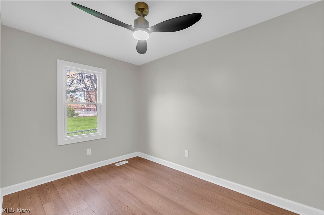 18155 Libby Road Maple Heights, OH 44137 - Photo 20 of 32 Room featuring light gray walls, wood-finish flooring, and white baseboards